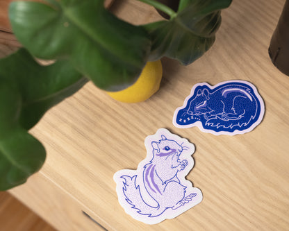 Thiskind collectible illustrated art vinyl stickers. Cute pink chipmunk or navy blue cozy sleeping chipmunk. Playful designs for kids and adults.